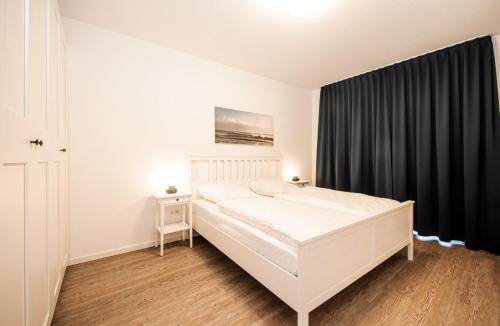 Postel nebo postele na pokoji v ubytování LM9-2-3 - Ferienwohnung Wremer Bogen Komfort