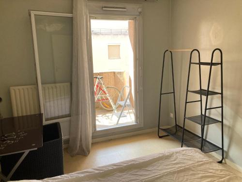 a bedroom with a bed and a ladder and a window at Chambre chez l'habitant à Lyon Centre in Lyon