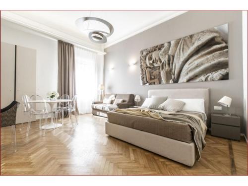 a bedroom with a bed and a table in it at Heart Milan Apartments Duomo District in Milan