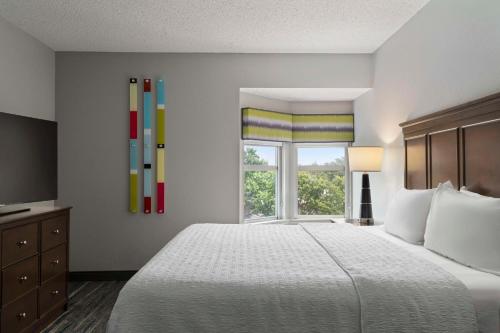 a bedroom with a large bed and a window at Hampton Inn & Suites Newport News-Airport - Oyster Point Area in Newport News