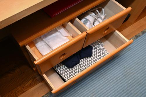 a wooden cabinet with drawerservationangeringukongukongukongukongukongukongukongython at 栂池高原　丘の上ホテル in Otari