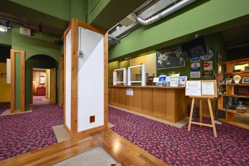 an entrance to a store with a counter in a room at 栂池高原　丘の上ホテル in Otari