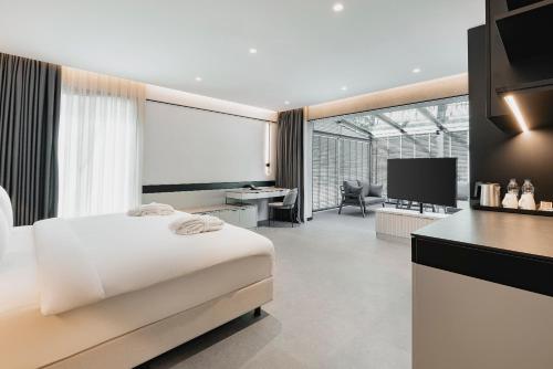 a bedroom with a bed and a desk and a television at INVENTIST Hotel Sports Academy Istanbul in Istanbul