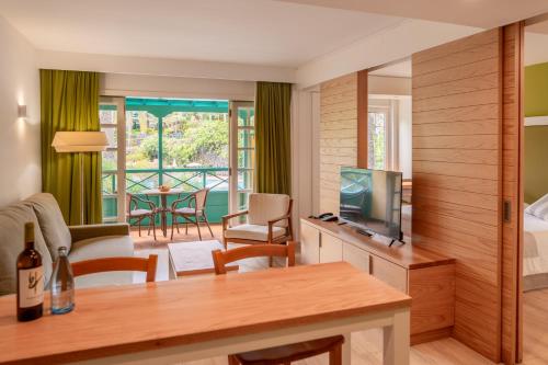 a living room with a television and a bed and a table at Hacienda San Jorge in Breña Baja