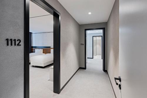 a hallway with a mirror and a bedroom at INVENTIST Hotel Sports Academy Istanbul in Istanbul