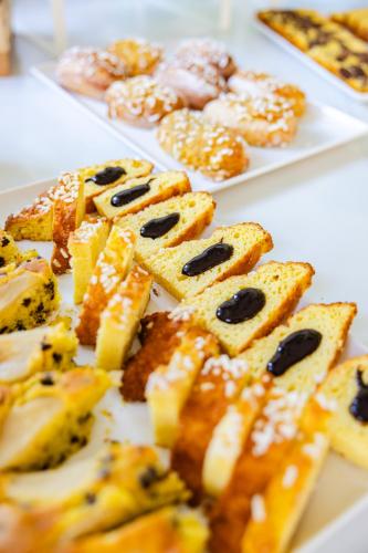 a bunch of pastries on plates on a table at Ciccio Hotel in Misano Adriatico