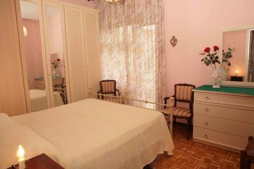 a bedroom with a bed and a dresser and a mirror at Ipanema B&B in Rome