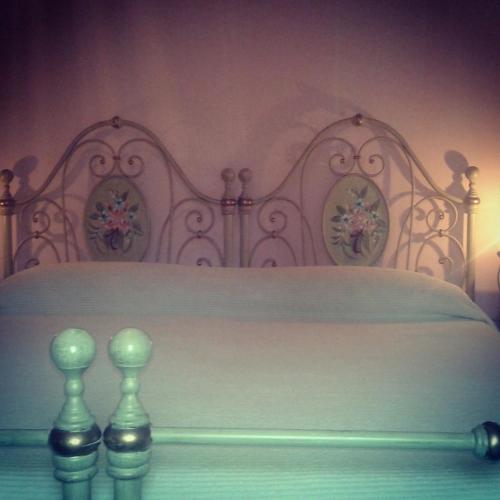 a bedroom with a white bed with a white bed frame at Ipanema B&B in Rome
