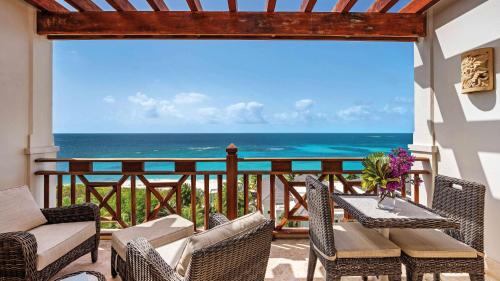 a balcony with a view of the ocean at Zemi Beach House, LXR Hotels & Resorts in Shoal Bay Village