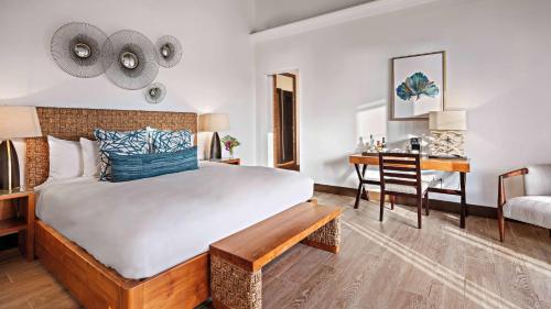 a bedroom with a large bed and a desk at Zemi Beach House, LXR Hotels & Resorts in Shoal Bay Village