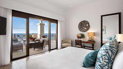 a bedroom with a bed and a view of the ocean at Zemi Beach House, LXR Hotels & Resorts in Shoal Bay Village