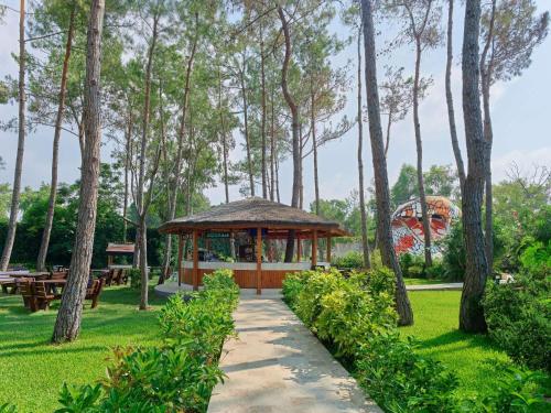 a gazebo in a park with trees at Maxx Royal Belek Golf Resort in Belek