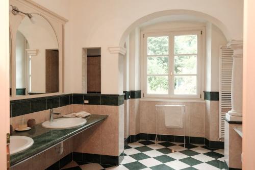 a bathroom with two sinks and a window at Villa Hélène in Solto Collina