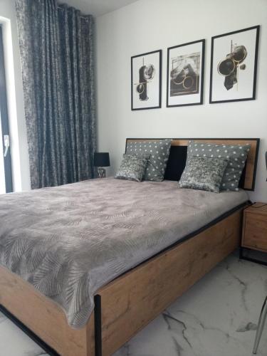 a bedroom with a large bed with a wooden frame at Apartament Bieszczadzka A 8 Lesko in Lesko