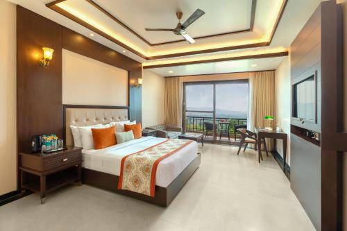 a hotel room with a bed and a balcony at Mahua Bagh Resort Kumbhalgarh in Kumbhalgarh