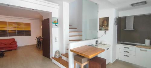 a kitchen with a table and a dining room at John's house in Rhodes Town