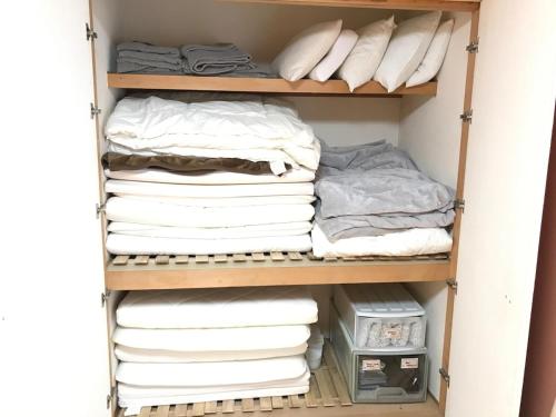 a closet filled with lots of towels at Marine House - Vacation STAY 77620v in Koshigoe