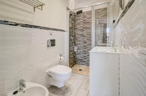 a white bathroom with a toilet and a shower at Cosy Mareverde FREE WIFI by Olax Rentals in Adeje