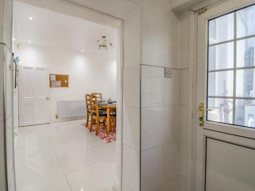a bathroom with a walk in shower next to a table at 28 Water Street in Skipton