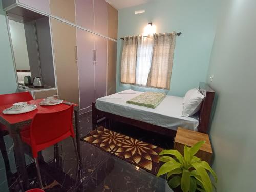 a small room with a bed and a table at Hill View Retreat - Coorg in Madikeri