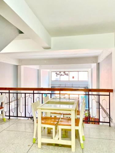 a dining room with a table and chairs on a balcony at No7 Guesthouse in Krabi