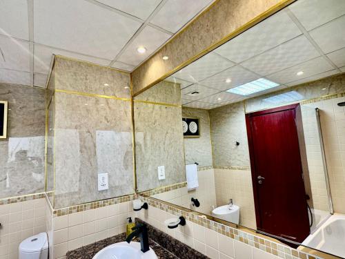 a bathroom with a red door and a mirror at 2BR Luxury Apartment Marina View in Dubai