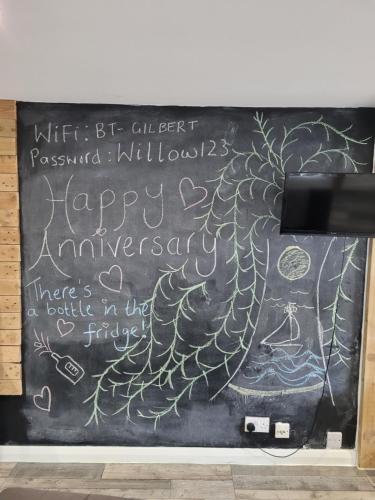 a chalk board with a happy anniversary written on it at Willow Inn in Kent