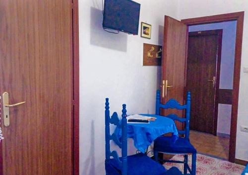 a room with a table and two chairs and a door at Hotel Europa in Minori