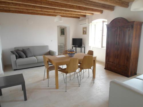 a living room with a wooden table and chairs at Apartments Antica Orsera in Vrsar