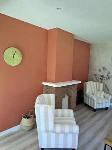 a living room with two chairs and a fireplace at Family House Wakker in Eemnes