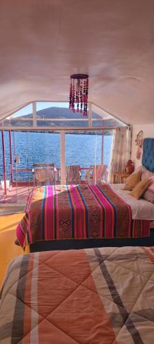 a bedroom on a boat with a bed on a ship at Uros Titicaca coila lodge in Puno