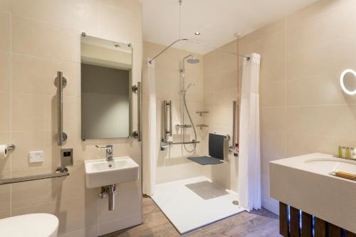 a bathroom with a sink and a shower at Hilton Aberdeen TECA in Aberdeen