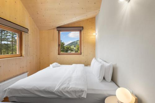 a bedroom with a white bed and a window at Hupni Rusutsu in Rusutsu