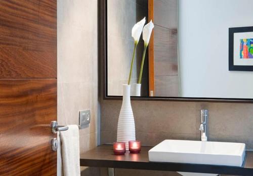 a bathroom with a sink and a vase on a counter at Beautiful Villa Ambar in Puerto del Carmen