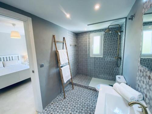 a bathroom with a shower and a toilet and a sink at Escape to Serenity - 3 Bedroom Townhouse by the Sea! in Marbella