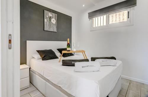 a bedroom with a white bed with a table on it at Cosy Mareverde FREE WIFI by Olax Rentals in Adeje