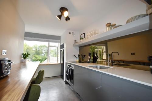 a kitchen with a sink and a counter top at Modern Apartment Central Woodstock with Parking in Woodstock
