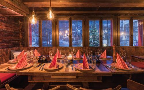 a large wooden table with red paper boats on it at Alpenclub in Engelberg