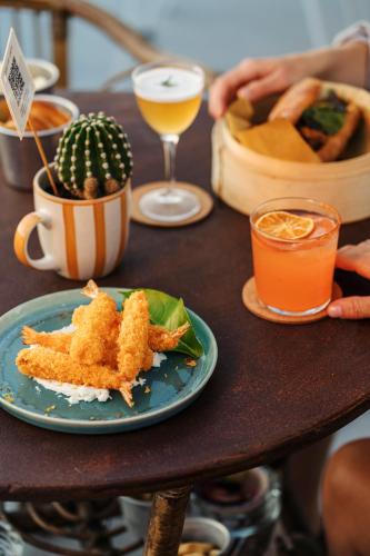 a table with a plate of food and a drink at Paradise Relais Villa Janto' in Ischia