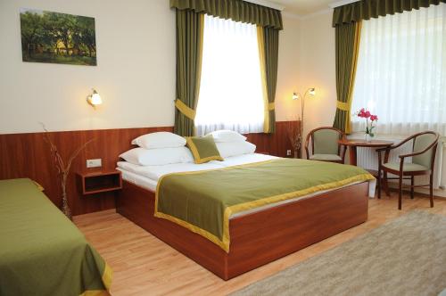 Postel nebo postele na pokoji v ubytování Apartman Bella Hotel