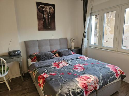 a bedroom with a bed and an elephant picture on the wall at Meduliceva apartman in Zagreb