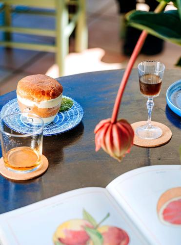 a table with a pastry and a glass of wine at Paradise Relais Villa Janto' in Ischia