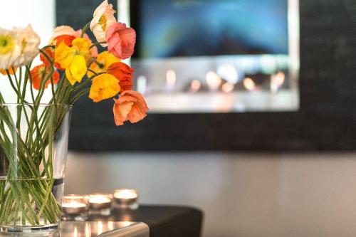 a vase filled with flowers sitting on a table at Ganter Hotel & Restaurant Mohren in Reichenau