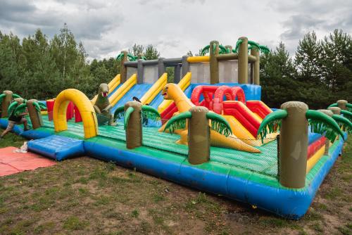 a large inflatable water park with a water slide at Senelio Romo Sodyba in Molėtai