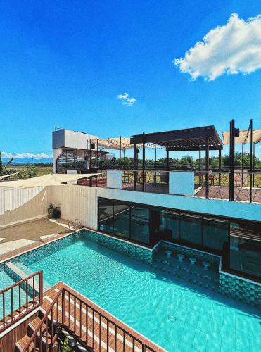 a large swimming pool on top of a building at Urban Glamp Resort Iloilo in Oton