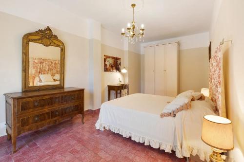 a bedroom with a bed and a mirror and a dresser at Pratolina in Savona