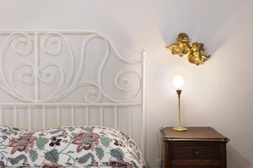 a bedroom with a bed and a lamp on a night stand at Pratolina in Savona