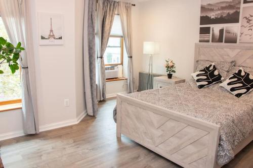 a bedroom with a bed and a large window at Modern 1BR Exclusive Space in Historic Brooklyn in Brooklyn