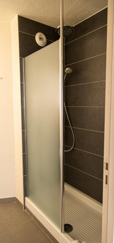 a shower with a glass door in a bathroom at Campanile Toulouse - Blagnac Aéroport in Blagnac