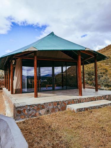 a gazebo with a green roof on a hill at Aloeron at Patatsfontein Stay in Montagu